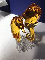 Close-up angle showing two amber Swarovski crystal seahorses on a clear crystal coral base, highlighting faceted details.