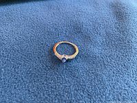 Front view of ring on blue fabric background