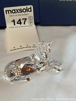 Swarovski crystal donkey figurine from front angle showing detailed faceted design and lying position.