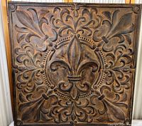 Full front view of 36x36 inch composite wall panel with Fleur-de-lis and Gothic floral pattern in bronze and black textured finish.