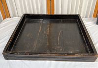 Top view of vintage wooden market tray showing distressed dark wood surface with wear marks and scratches