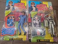 Photo showing front of unopened Austin Powers and Moon Mission Dr. Evil action figures in original packaging with character images and accessories visible.
