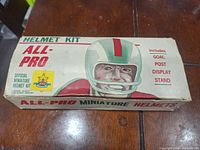 Vintage All-Pro miniature helmet kit box with CFL helmet artwork and list of included parts (goal post, display stand).