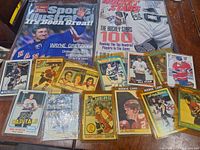 Overview of the collection laid out on table showing two hockey magazines and multiple hockey cards.