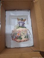 Music box inside protective foam packaging within the box.