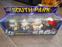 Front view of unopened original box with four South Park boy band figures inside.