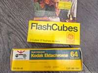Box of GE FlashCubes with yellow packaging showing 3 cubes totaling 12 flashes, unopened.