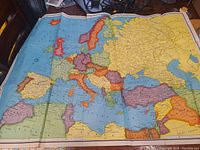 1944 World War II era political map of Europe, showing country borders and territorial divisions of the time, laid flat on a table.