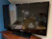 Front view of LG 47 inch flat screen TV on black stand showing screen and bezel.
