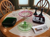 Overview photo showing full lot on table with various colored glassware and candlesticks