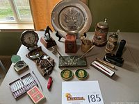 Overview of the desk collection including compasses, beer steins, tray, utensils, magnifiers, and figurines.