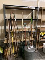 Full view of the metal frame shelving unit with particle board shelves, showing the empty shelves and the black metal frame.