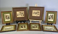 Overview photo showing all eight framed etchings arranged on a table, including two smaller sized frames and six larger frames.