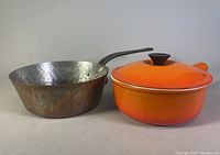 Photo of both pots side by side on neutral background showing size and condition