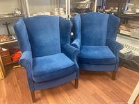 Front view of both wingback arm chairs showing shape and upholstery
