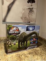 Front view of Jurassic World Apatosaurus toy box showing dinosaur image, logo, and toy length indicator.
