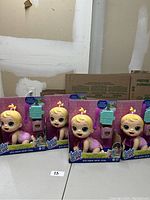 Four Baby Alive dolls in original packaging arranged side by side showing front view.