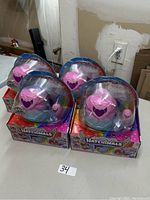 Photo showing 4 Hatchimals toys in their original packaging on a table, unopened and arranged in a group