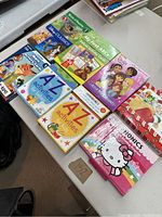 Top view of boxed sets showing colorful covers of Disney Classics, Sesame Street ABC cards, 4 Dora books, A to Z activities for babies, and others.