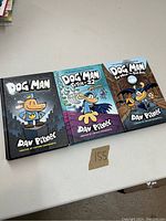 Three Dog Man books by Dav Pilkey laid flat showing front covers.