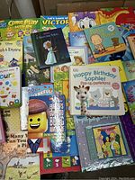Wide view of a collection of popular children's books in good condition showing various titles and colorful covers including Pooh & Eeyore, Lego Movie, Puppy Learns to Say Please.