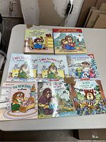 Eight Mercer Mayer children’s books arranged on a table showing front covers. Titles visible include multiple 'I Was So Mad' books, 'Just Me and My Dad', 'The New Baby', and collections including 'Just a Little Critter Collection' and 'Little Critter Lot 4-Book Collection'. Covers feature colorful cartoon animal characters.