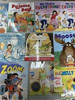 Collection of Robert Munsch children's books arranged on a surface showing covers of nine books.
