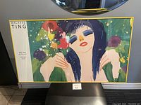 Full front view of colorful framed art print featuring a woman with dark hair and vivid makeup, signed by Walasse Ting and featuring Bel Ami Art Gallery text.