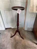 Full view of tall wooden Bombay table showing round top, central column and tripod legs