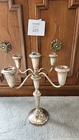Image showing the 5 candle holders with wax residue, tarnished sterling silver finish, weighted base