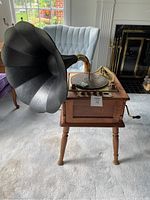 Full view of the Grafonola radio phonograph with large black gramophone horn on wooden stand.