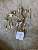 Overview of flatware assortment on carpet