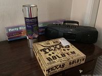 Photo showing the Sony portable radio cassette player, Texas Hold'em poker board game box, and Party Black Light Set packaging.