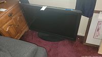 Photo of 36-inch Insignia flat screen TV leaning against a wall, showing its overall size and shape.