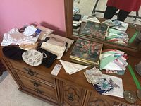 Overview of table with vintage handbags, gloves, tank bras, hankies and scarves.