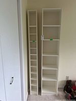 Front view of both laminate shelving units side by side against wall, showing size and shelving configuration.