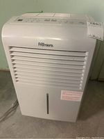 Front view showing Premiere brand name and grille vents with control panel on top.