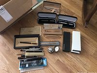 Overview of all included pens in cases and loose, plus inkwell