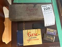 Top-down photo of Darwin Universal safety razor box, Gem Junior razor box, and several small blade boxes including Official and Golden 10.