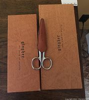 Three Gingher cutting tools including scissors with sheath and original boxes