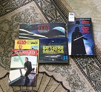 Photo shows all five books and blueprints laid out on carpet