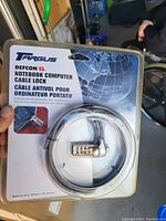 Front view of Targus Defcon CL notebook computer cable lock in original sealed packaging, showing coiled steel cable and combination lock.