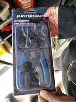 Mastercraft snap ring pliers set with interchangeable tips in original blister pack showing the blue handle and black steel tips inside.