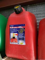 Red 6.6 gallon self vent fuel can with black and yellow cap and label on side.