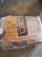 Sealed plastic bag containing Bernat latch hook rug pack with grandfather clock pattern and yarn bundles