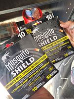 Two sealed packages of Mosquito Shield mosquito coils with citronella scent, one labeled 115g, 10 coils for 55 hours and the other 120g, 10 coils for 50 hours protection.