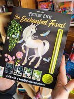 Box front of Picture Etch The Enchanted Forest showing unicorn, butterflies, flowers, and etching tool.