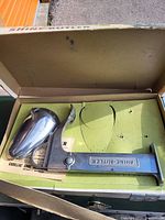 Photo of metal Shine-Butler shoe shine holder in original box.