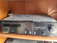 Front view of Yamaha RX-570 stereo receiver showing control knobs, buttons, tuning display, and headphone jack.