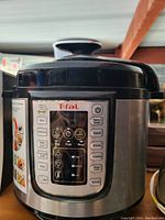 Photo showing the front digital control panel and exterior of the black T-fal food maker multi cooker.